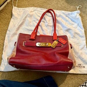 COACH Swagger Carryall handbag in a red and light pink colorblock pebble leather